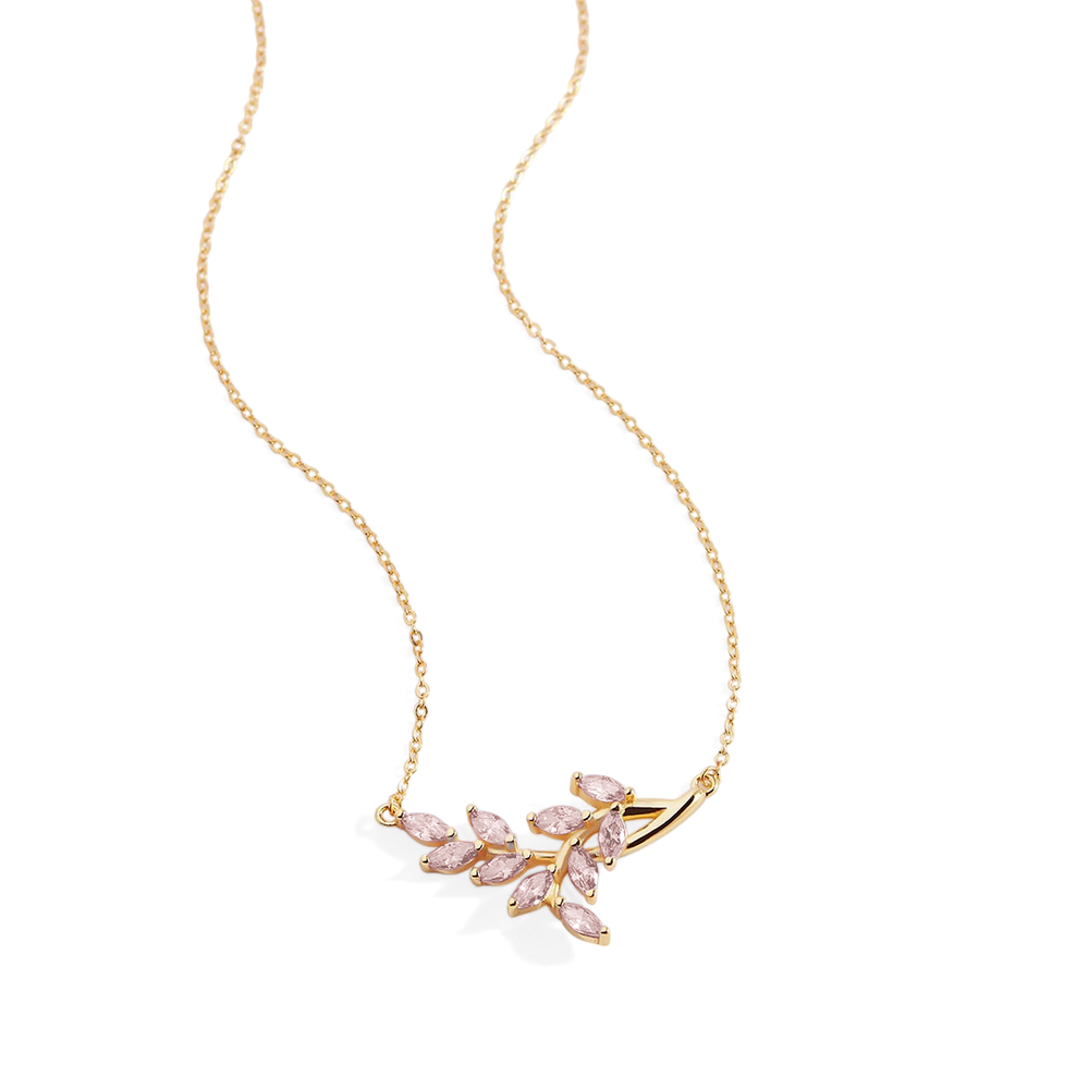 Gold necklace with pink gemstones on a light gray background