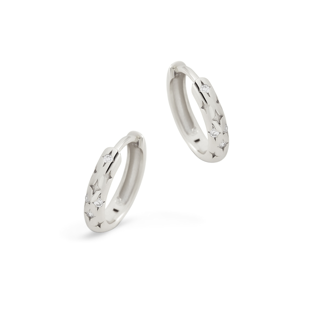 Two silver hoop earrings on a light gray background