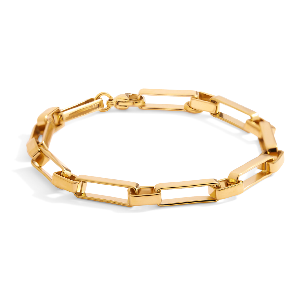 Gold chain bracelet on a light gray background