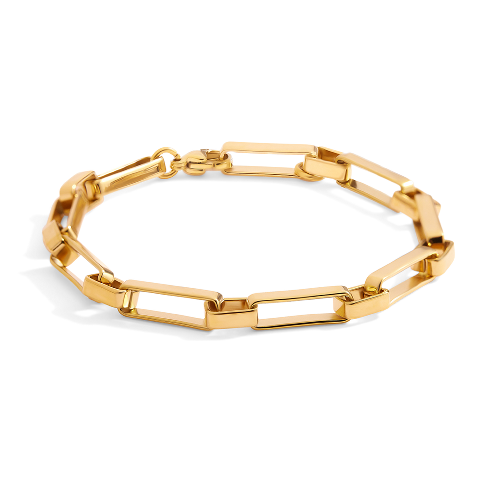 Gold chain bracelet on a light gray background