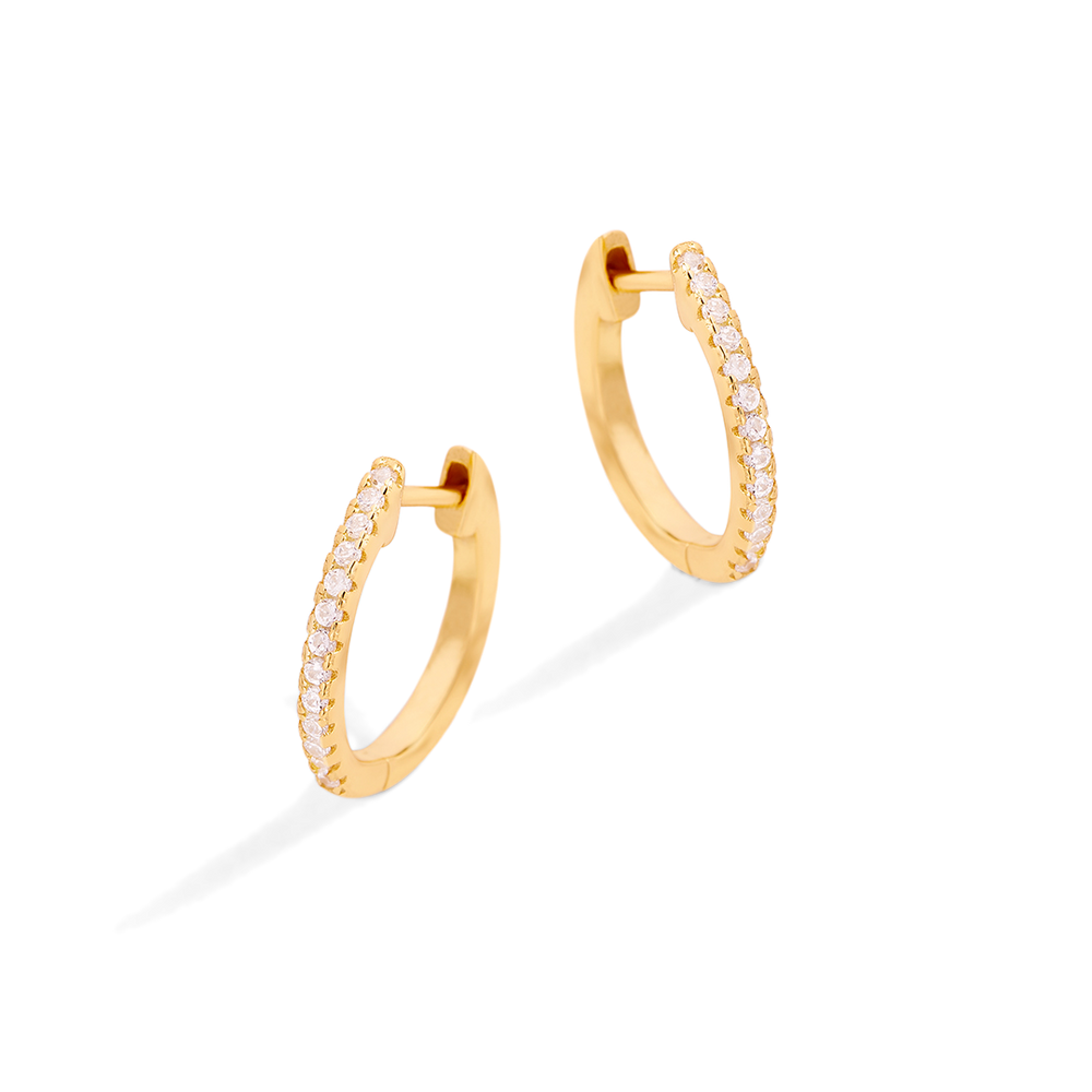 Gold hoop earrings with small diamonds on a light gray background