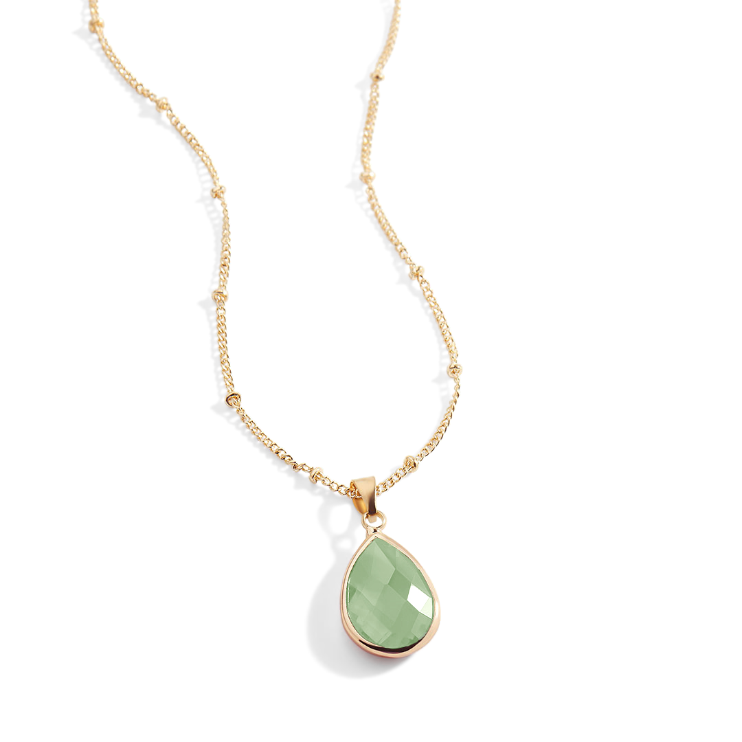 Necklace with a green teardrop pendant on a white background