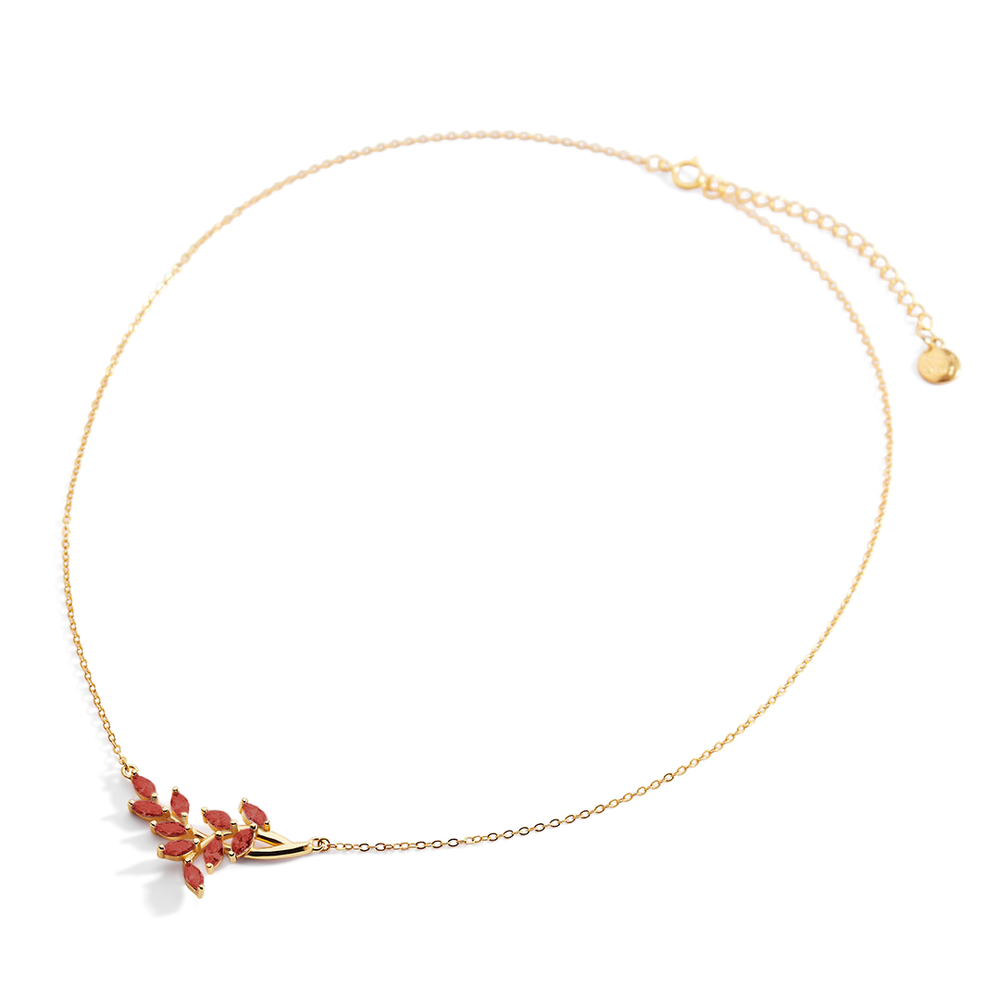 Gold necklace with a floral pendant on a light gray background