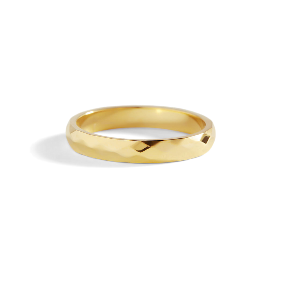 Gold ring on a light gray background