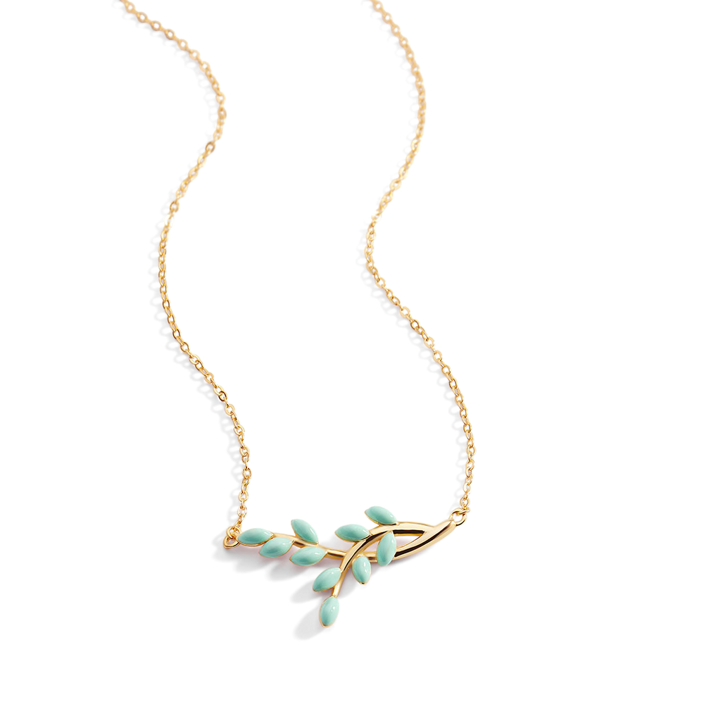 Gold necklace with green leaf pendants on a white background