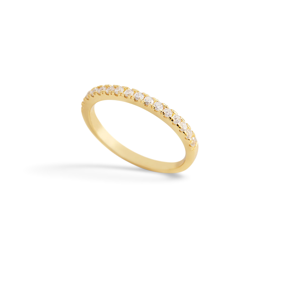 Gold ring with small diamonds on a light gray background