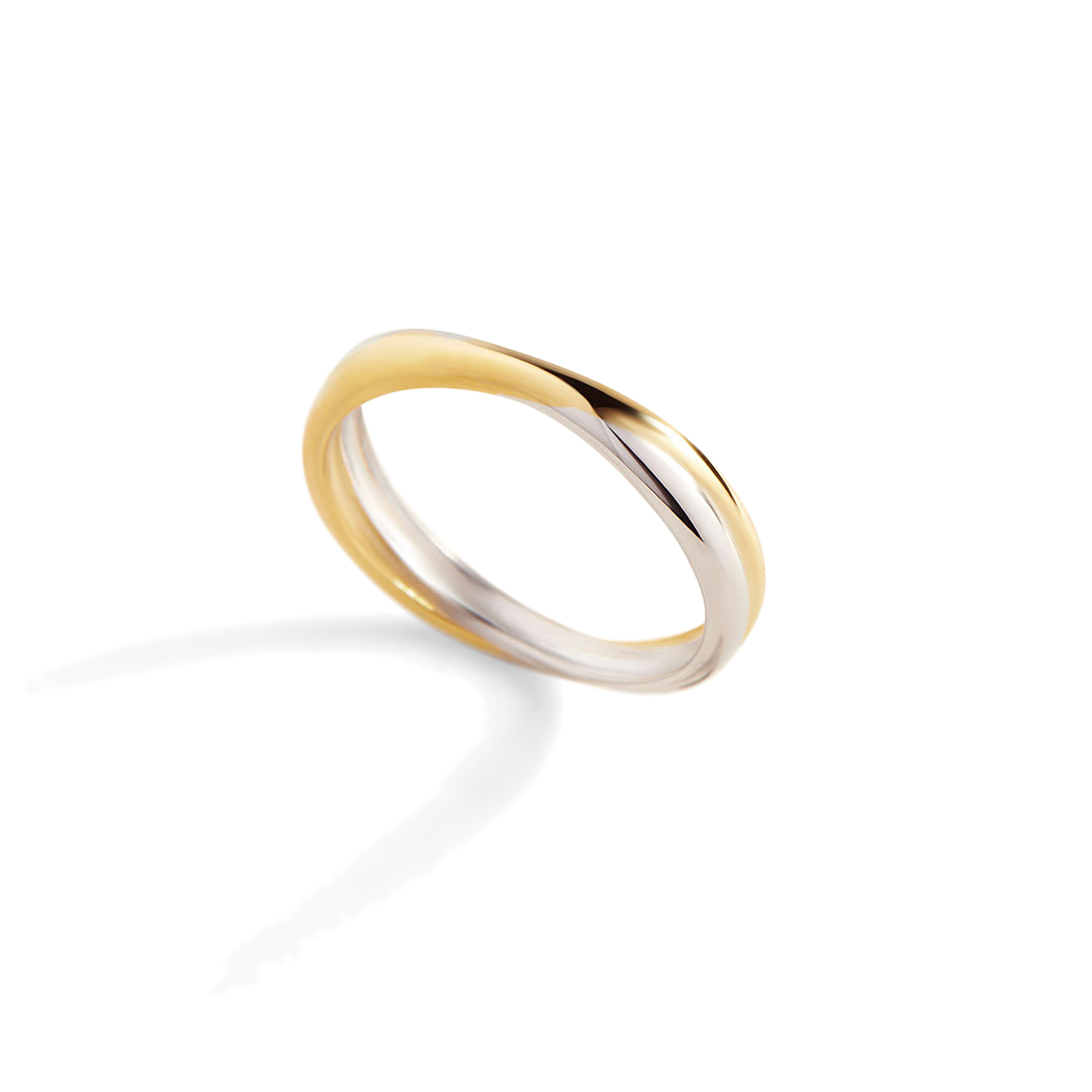 Two gold rings stacked on a light gray background