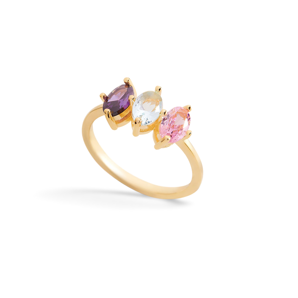 Gold ring with three colorful gemstones on a light gray background