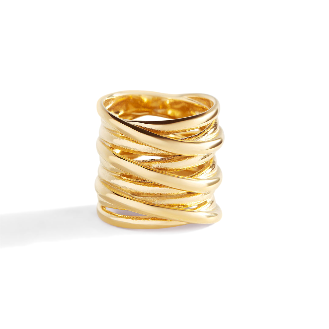 Gold ring with wavy design on a white background