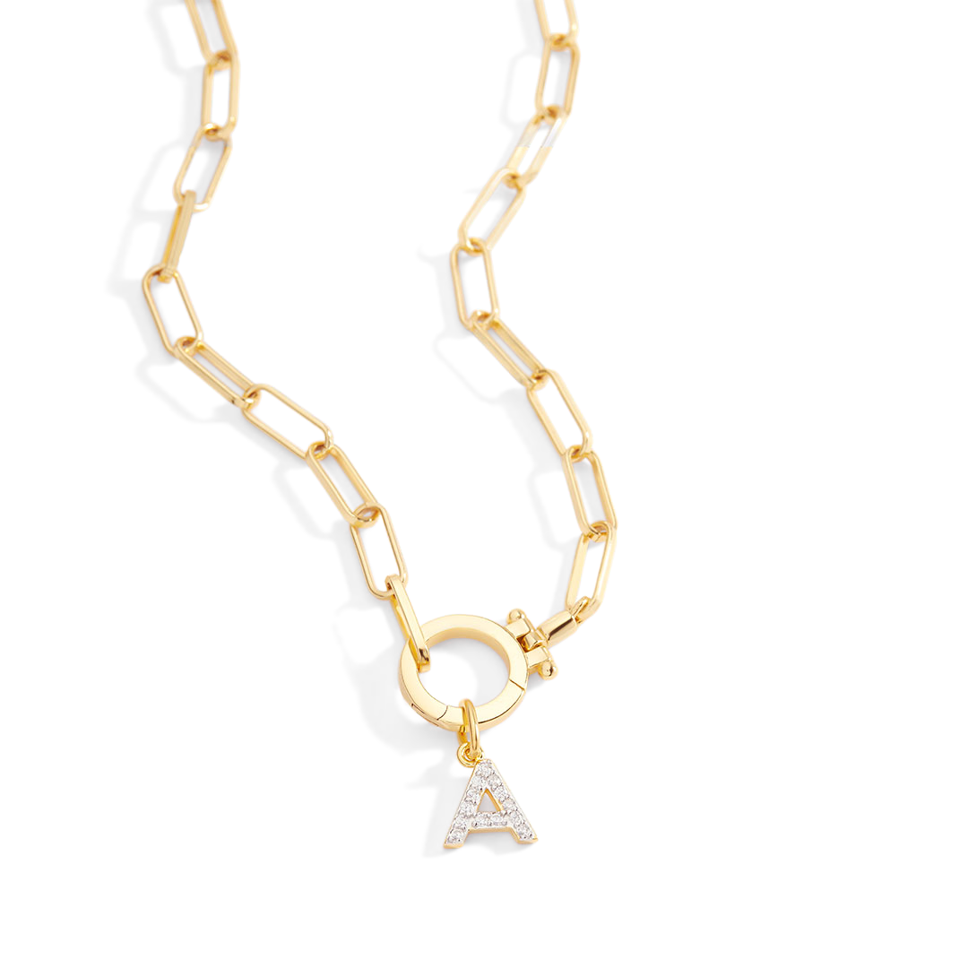 Gold chain necklace with a diamond-studded 'A' pendant on a light gray background