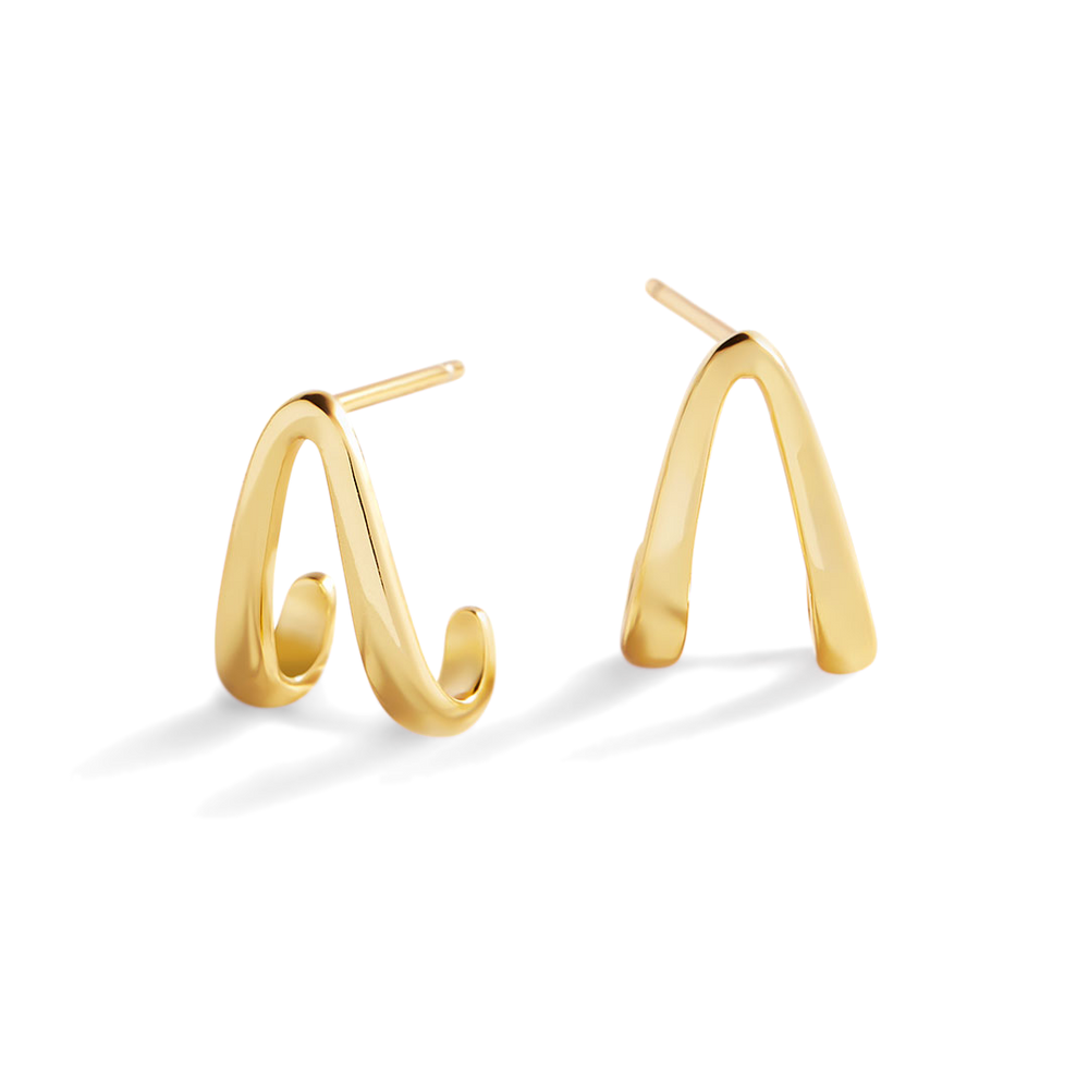 Gold hoop earrings on a light gray background