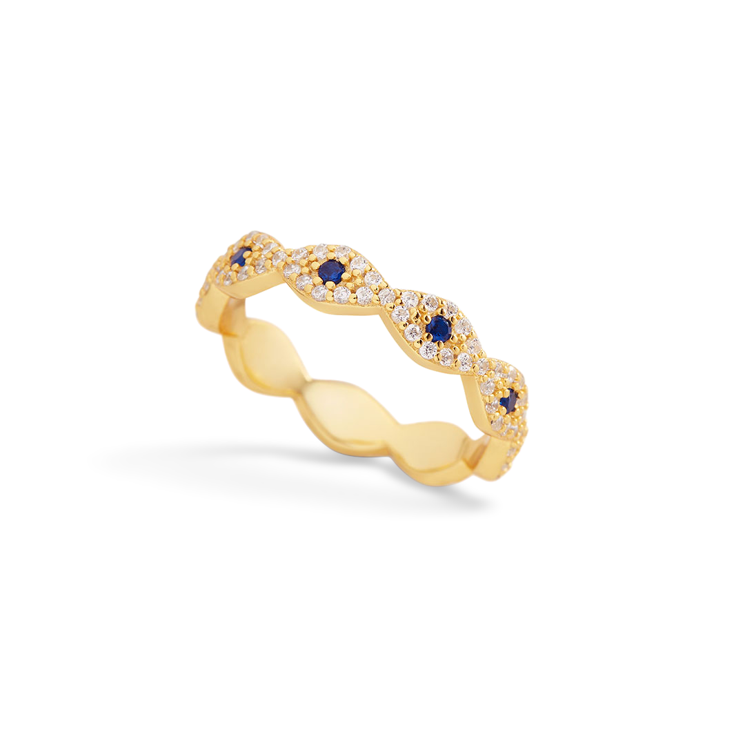 Gold ring with blue gemstones and clear stones on a light gray background