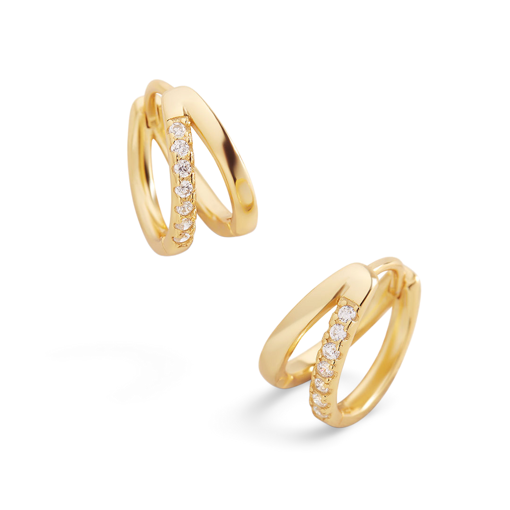 Gold hoop earrings with embedded diamonds on a light gray background