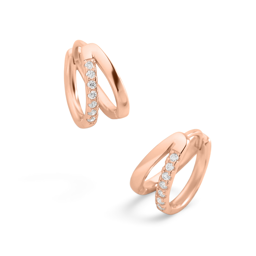 Rose gold hoop earrings with embedded diamonds on a light gray background