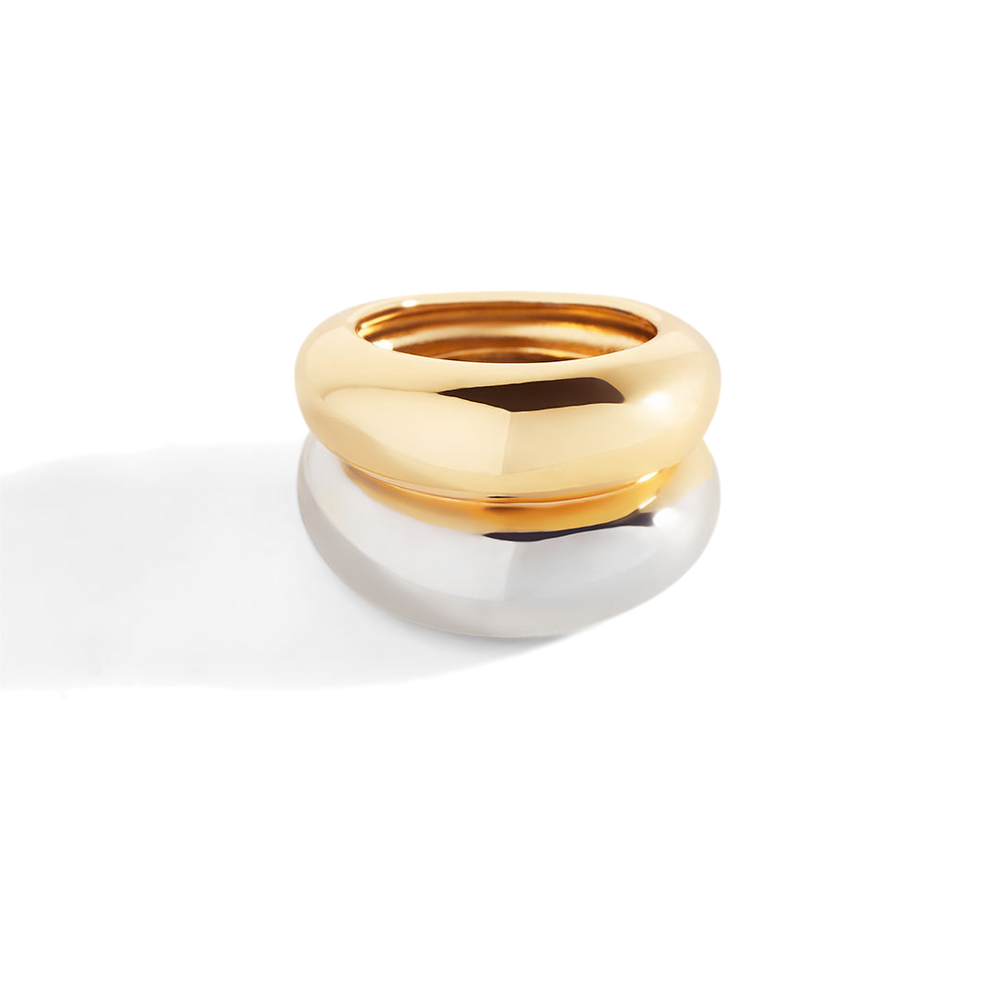 Two-tone gold and silver ring on a light gray background