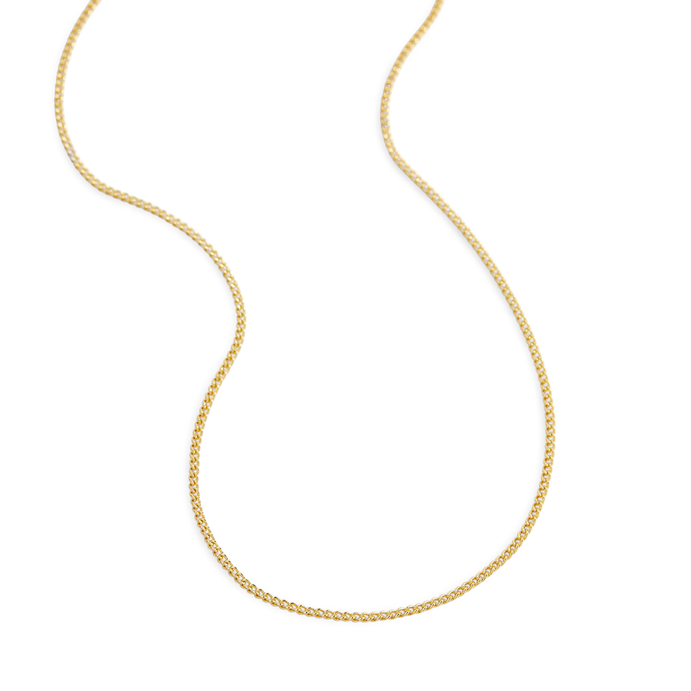 Gold chain necklace on a light gray background