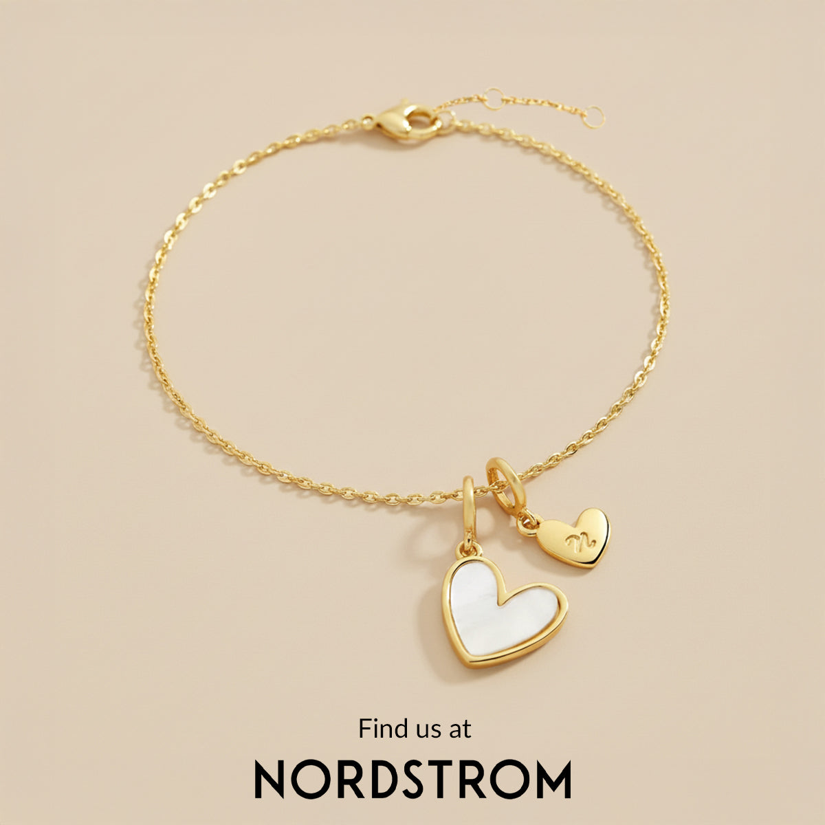 Gold bracelet with heart-shaped charms on a beige background, featuring Nordstrom branding.