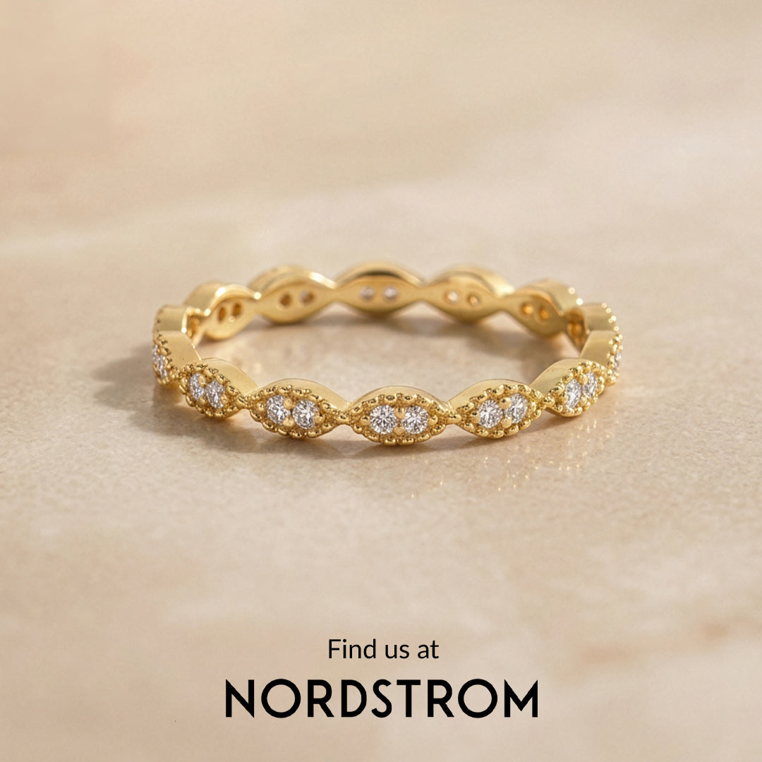 Gold ring with diamonds on a beige background, Nordstrom branding visible
