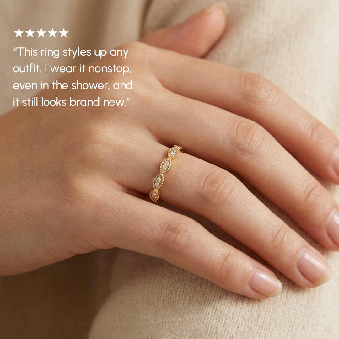 Gold ring on a hand with a neutral background