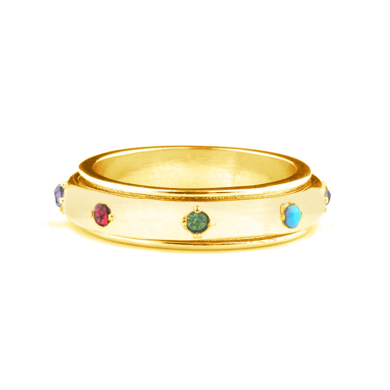A gold-colored stainless steel fidget ring with four multicolored gemstones set around its circumference.