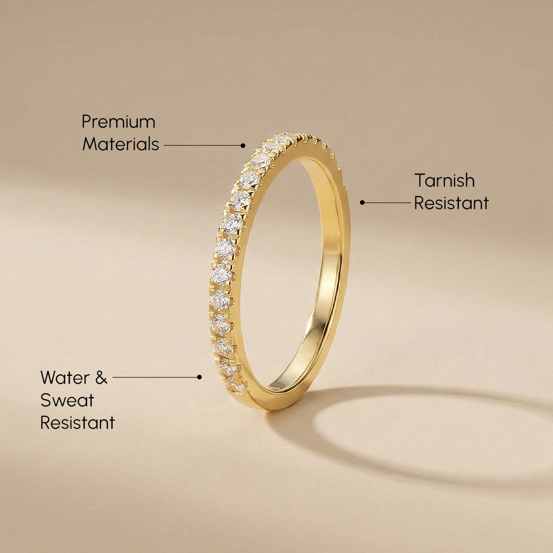 Gold ring with diamond accents on a beige background, labeled for material quality attributes.