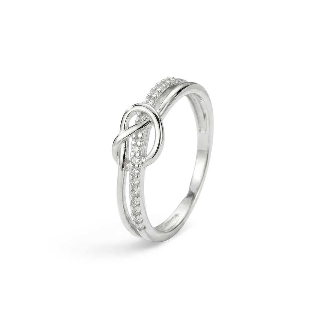 Silver ring with diamond accents on a light gray background