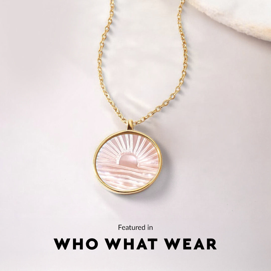 Necklace with a pink pendant on a light gray background, featuring 'WHO WHAT WEAR'.