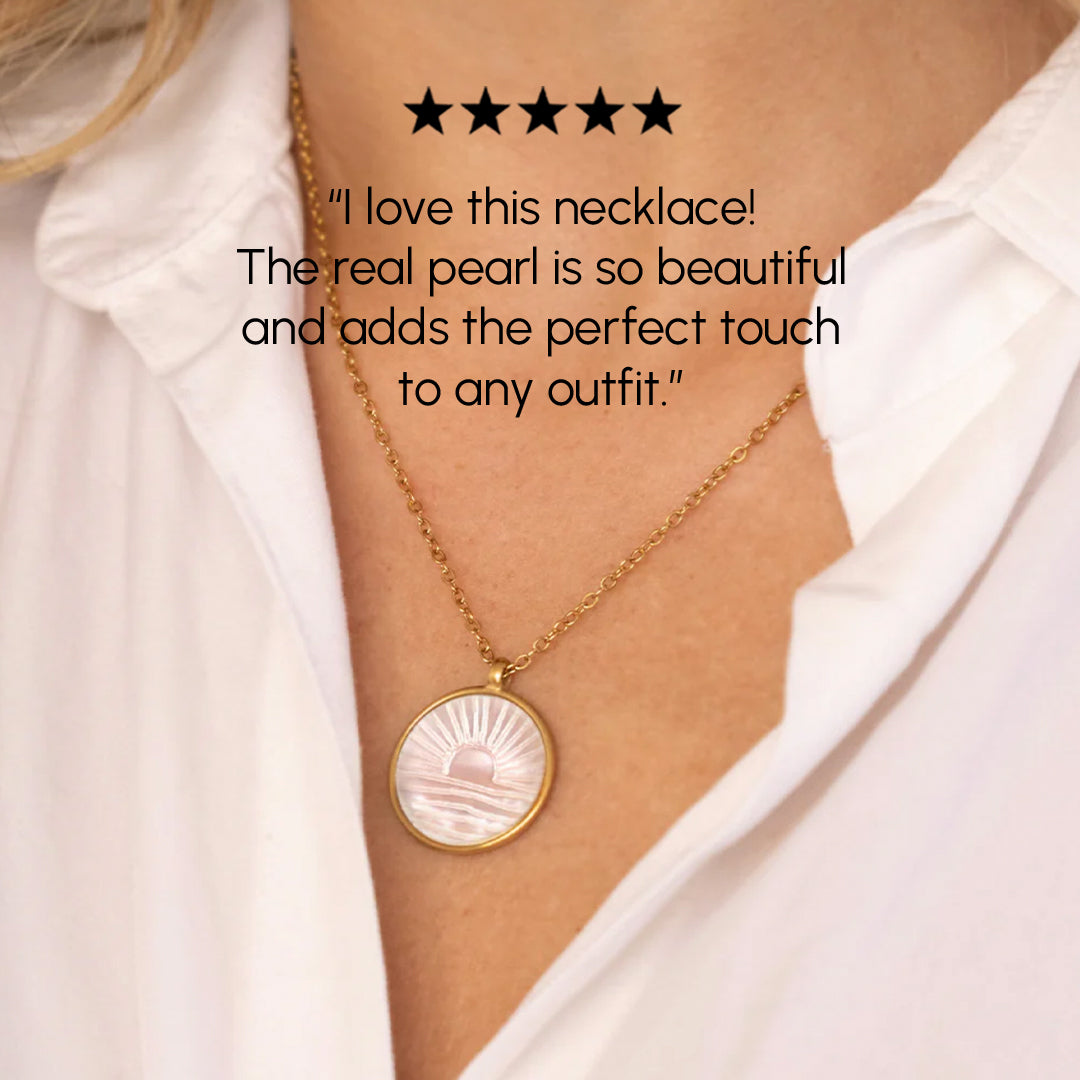 Necklace with a pearl pendant worn by a person, with a five-star rating and review text.