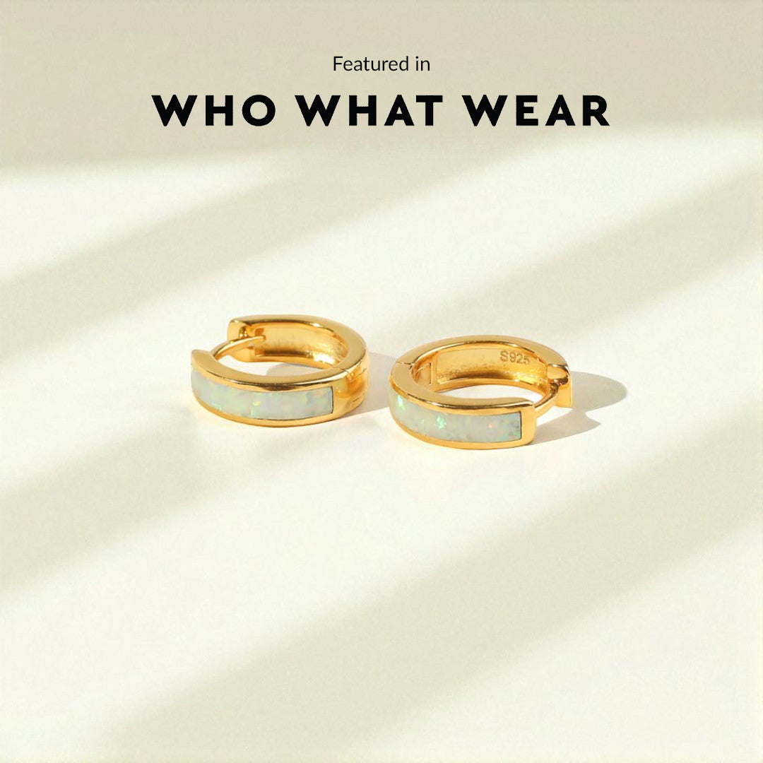 Gold hoop earrings with light blue centers on a beige background, featuring 'WHO WHAT WEAR'.