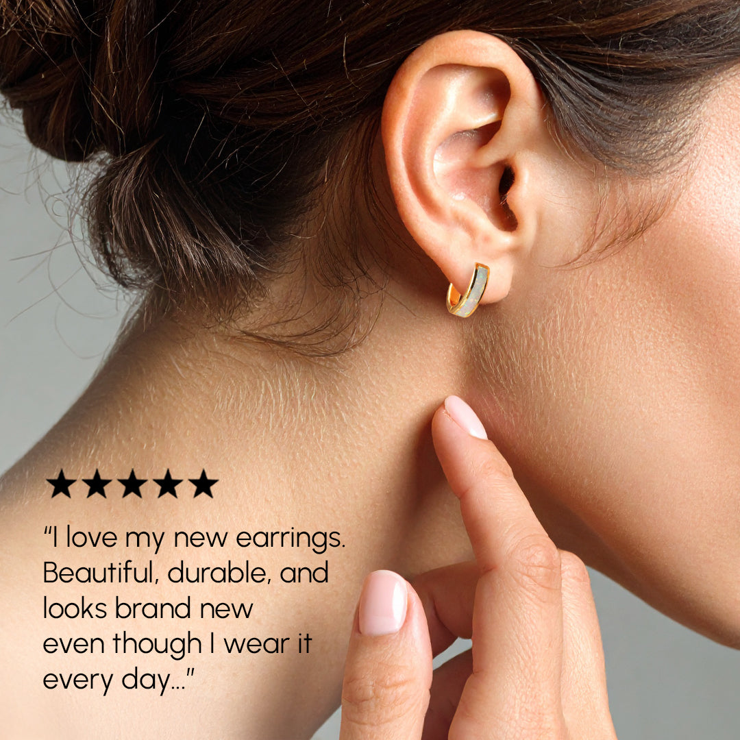 Close-up of an ear wearing a gold earring with a five-star rating text.