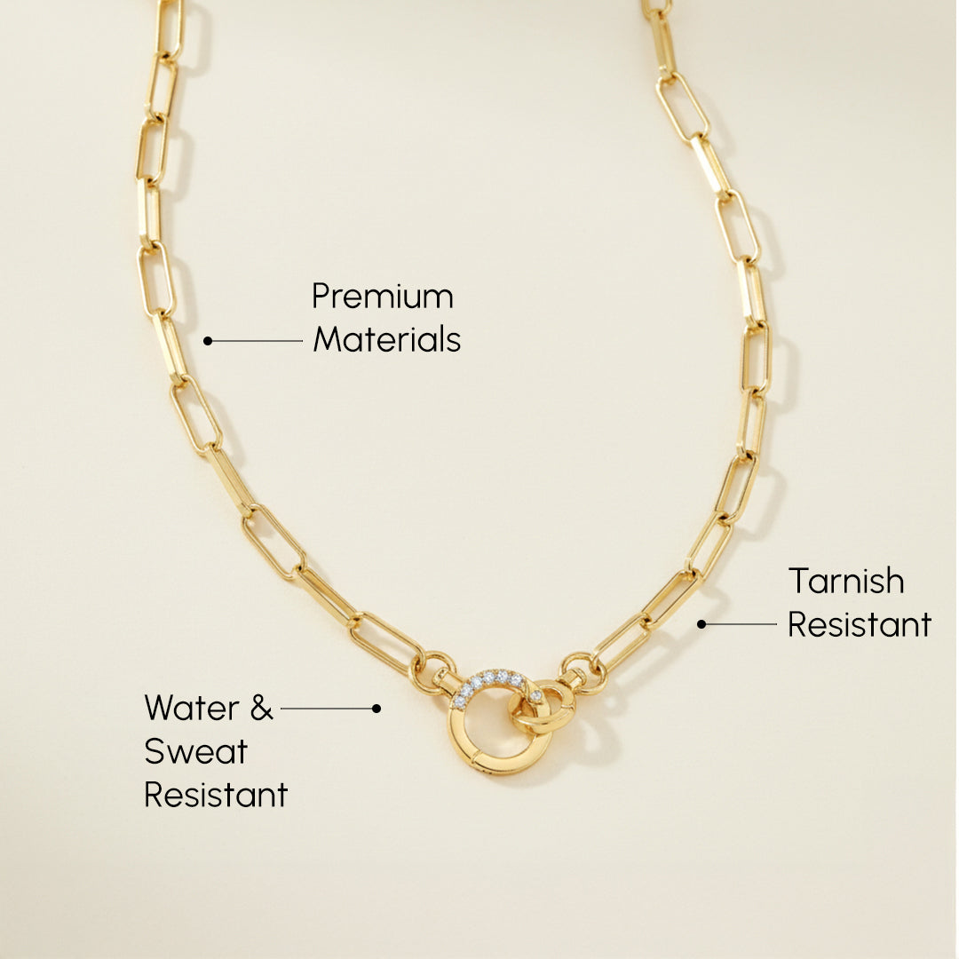 Gold chain necklace with text highlighting features on a beige background