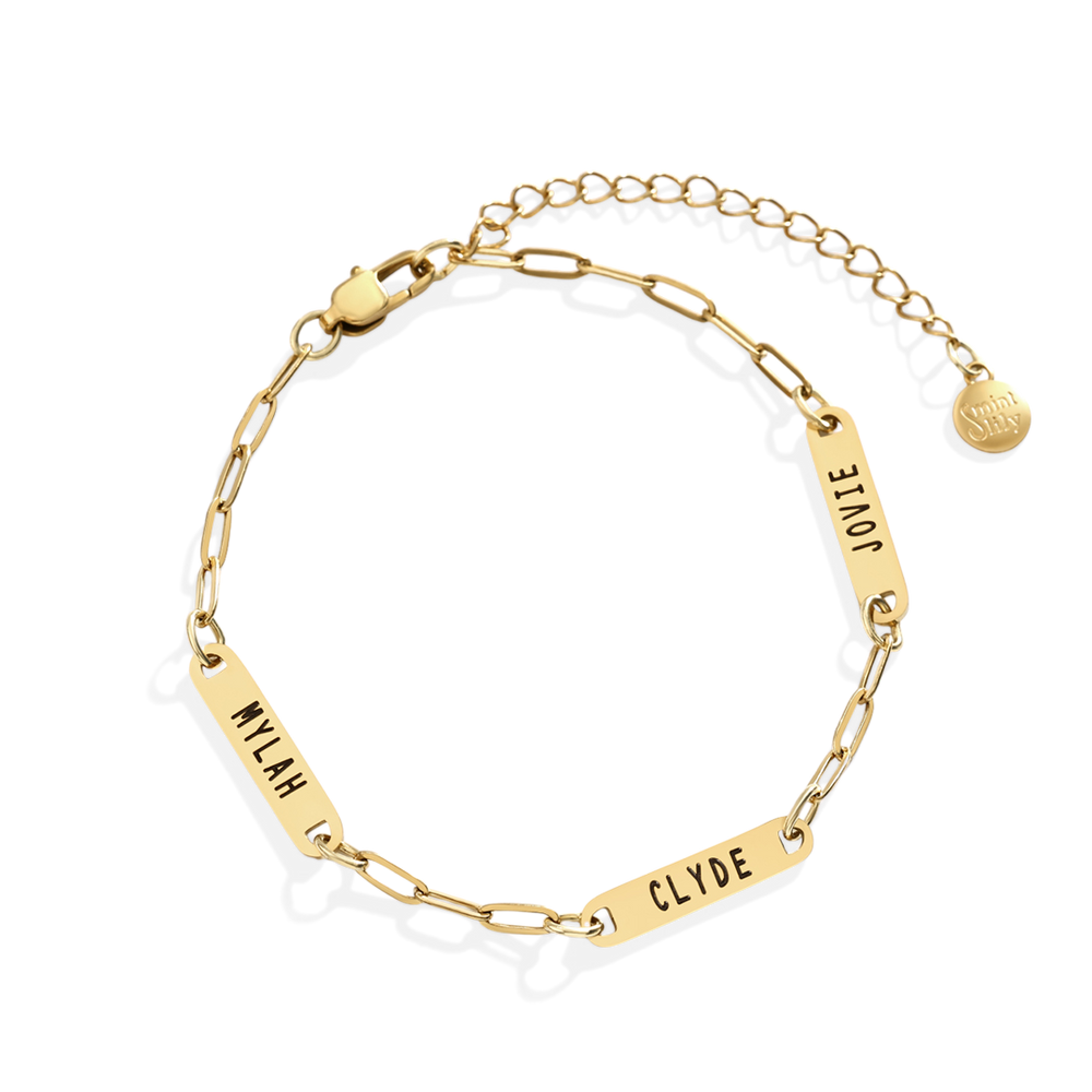 Gold chain bracelet with engraved names on a white background