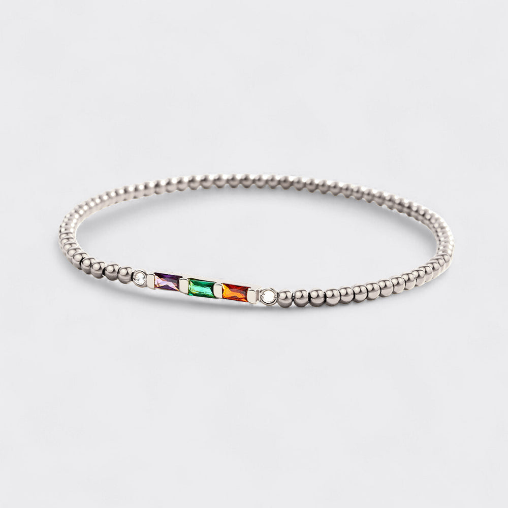 Silver beaded bracelet with colorful gemstones on a light gray background