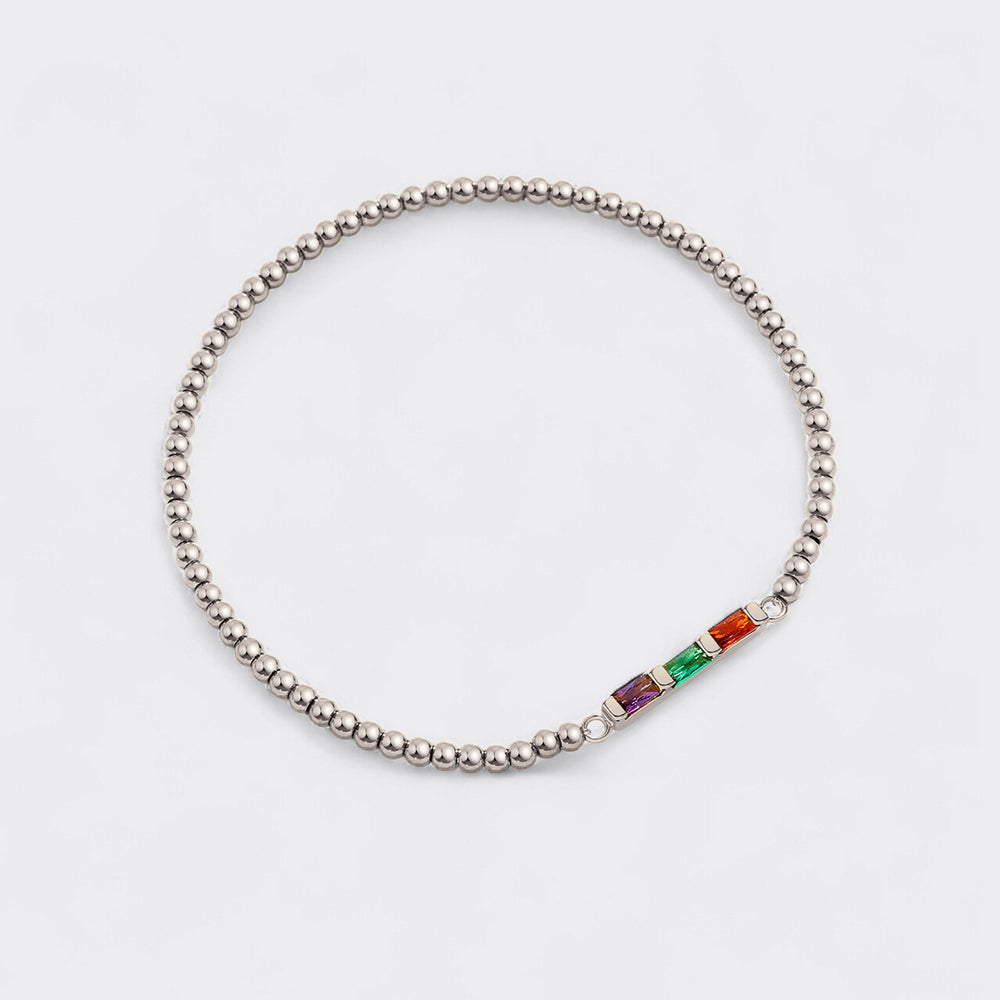 Silver beaded bracelet with colorful gemstones on a light gray background
