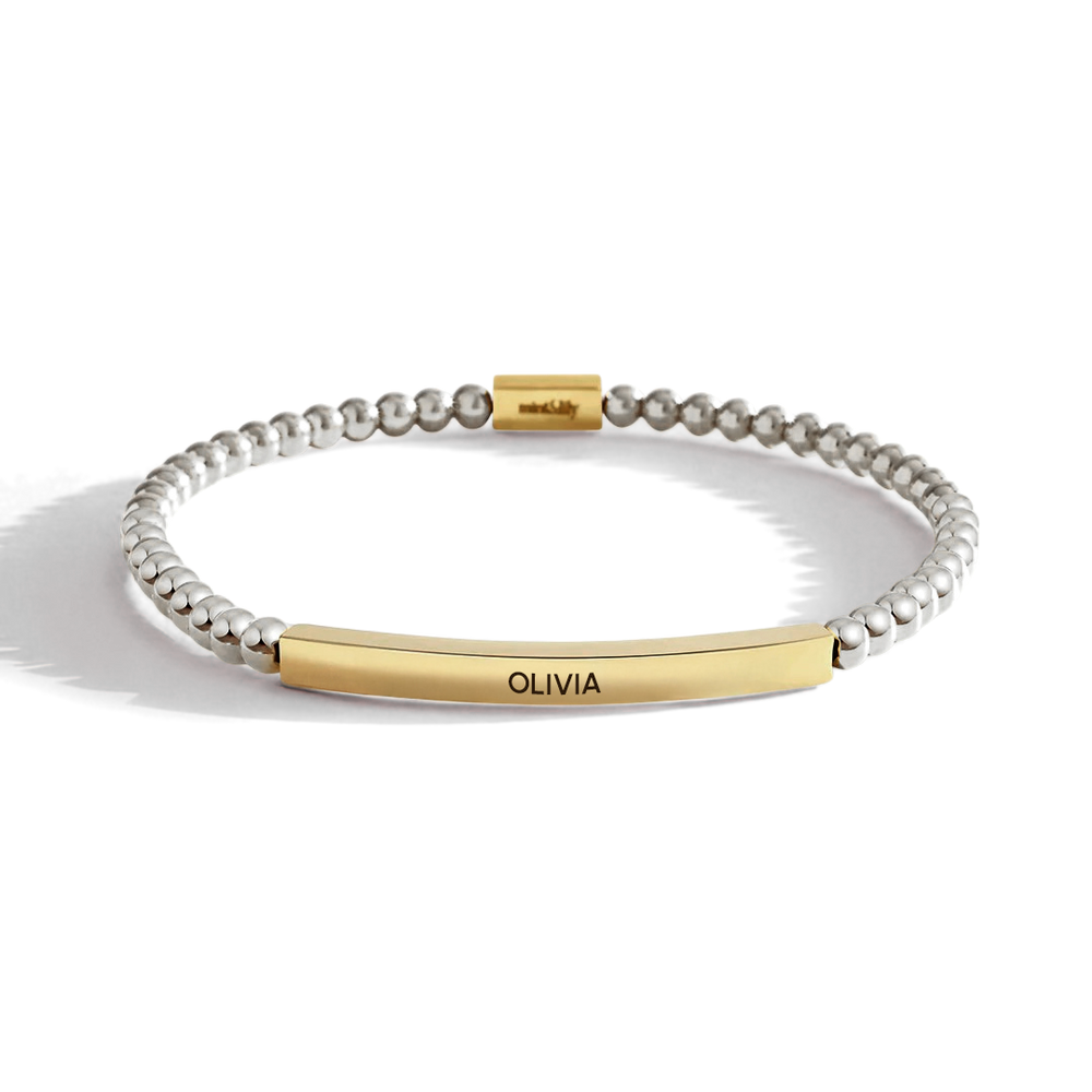 Bracelet with gold and silver beads on a white background