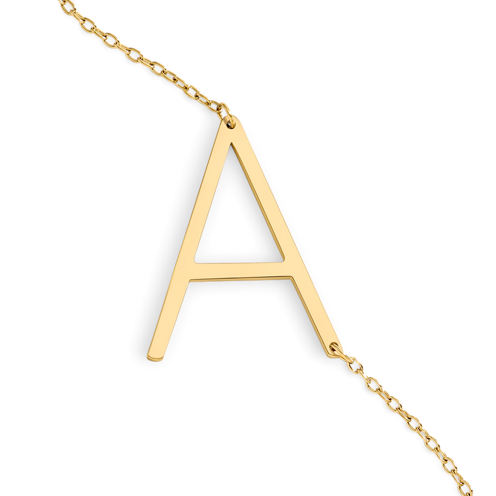 Gold necklace with a letter 'A' pendant on a light gray background
