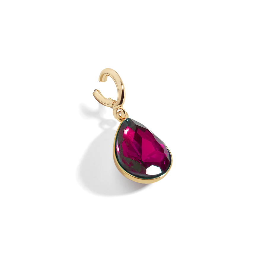 Gold pendant with a red teardrop-shaped gemstone on a white background