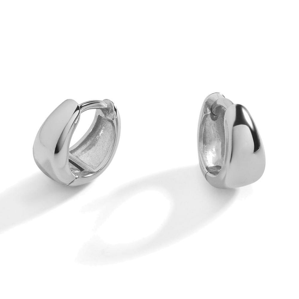 A pair of gold huggie hoop earrings with a teardrop design on a black background.
