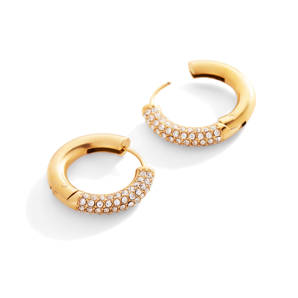 Gold hoop earrings with embedded stones on a light gray background