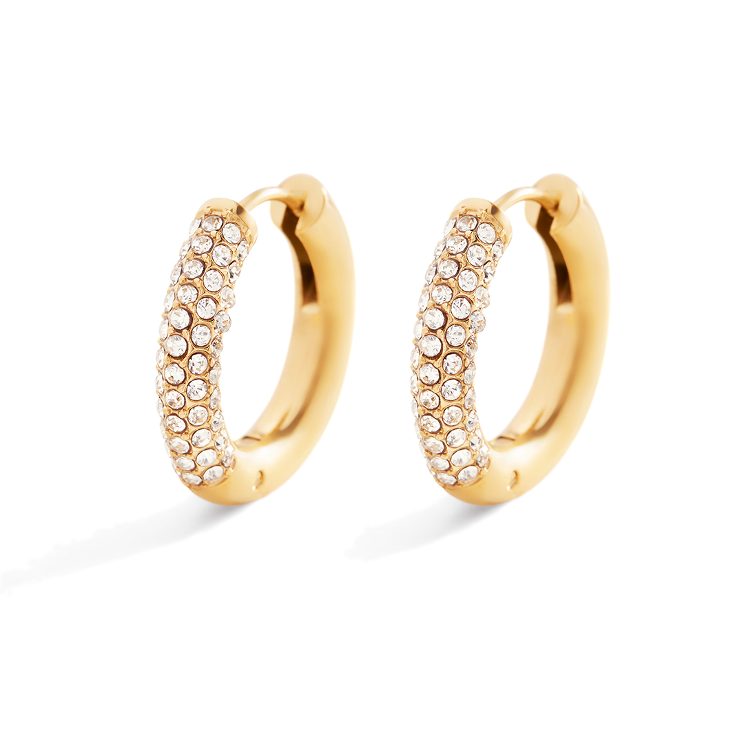 Gold hoop earrings with embedded stones on a light gray background