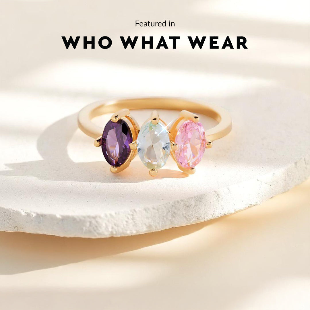 Ring with multicolored gemstones on a light background, featuring 'WHO WHAT WEAR'.