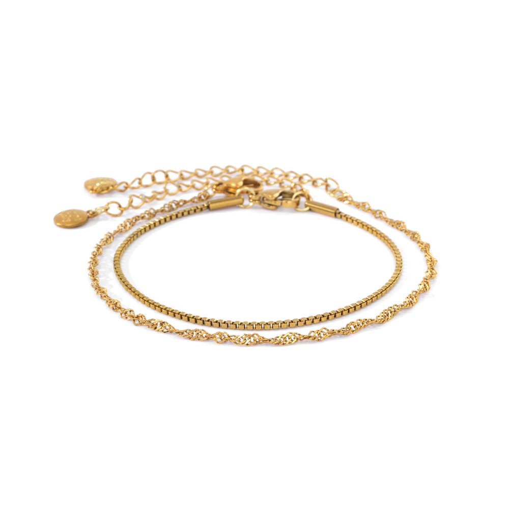 Gold Singapore twist chain bracelet and gold box chain bracelet laid side by side on a white background.