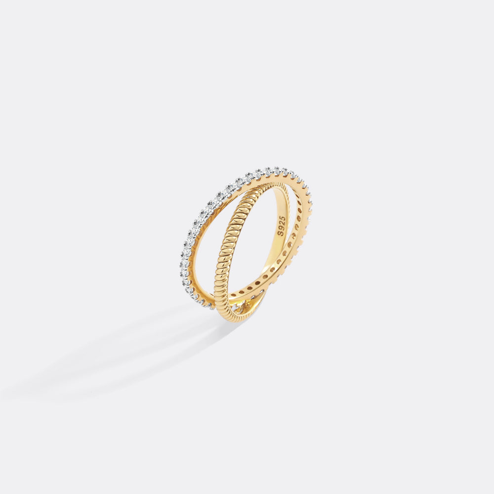 Gold ring with small diamonds on a light gray background