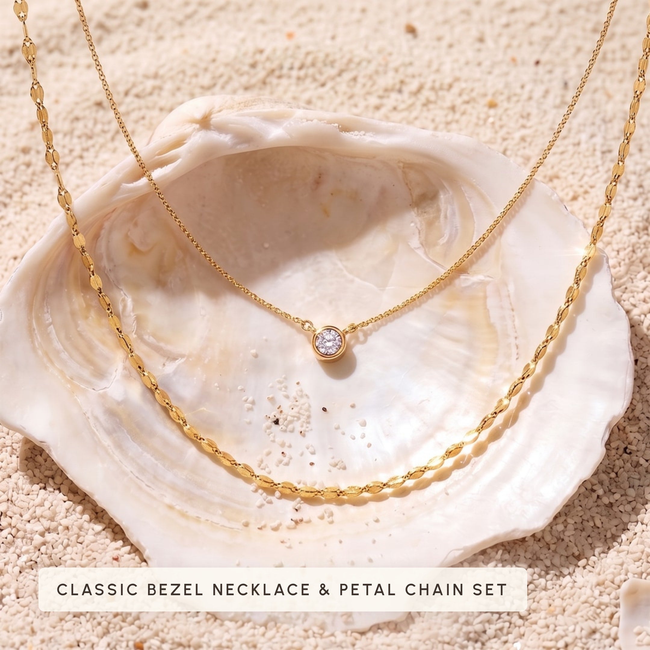 Classic bezel necklace and petal chain set in a shell on sand