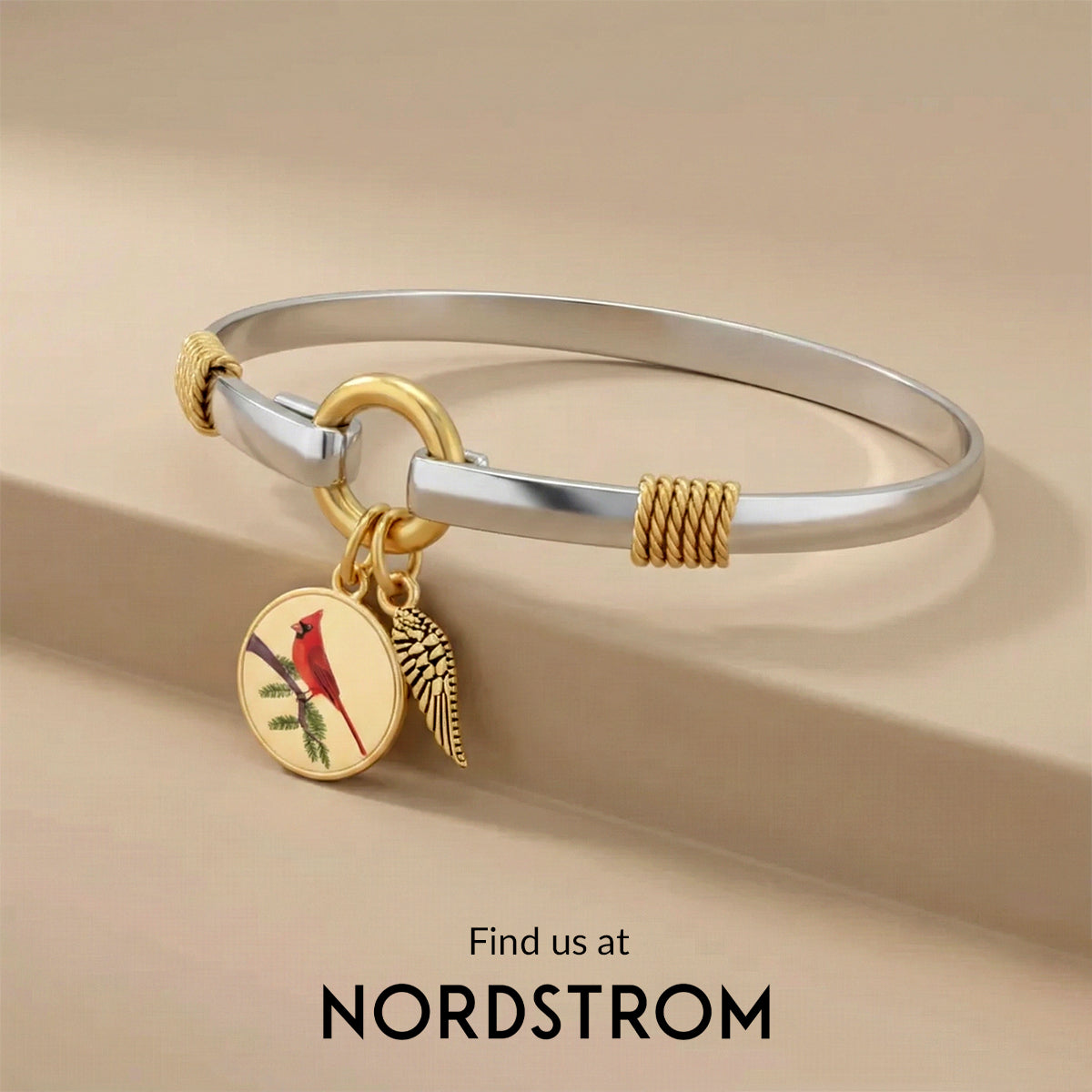 Silver and gold bracelet with a charm featuring a cardinal on a beige background, Nordstrom branding visible.