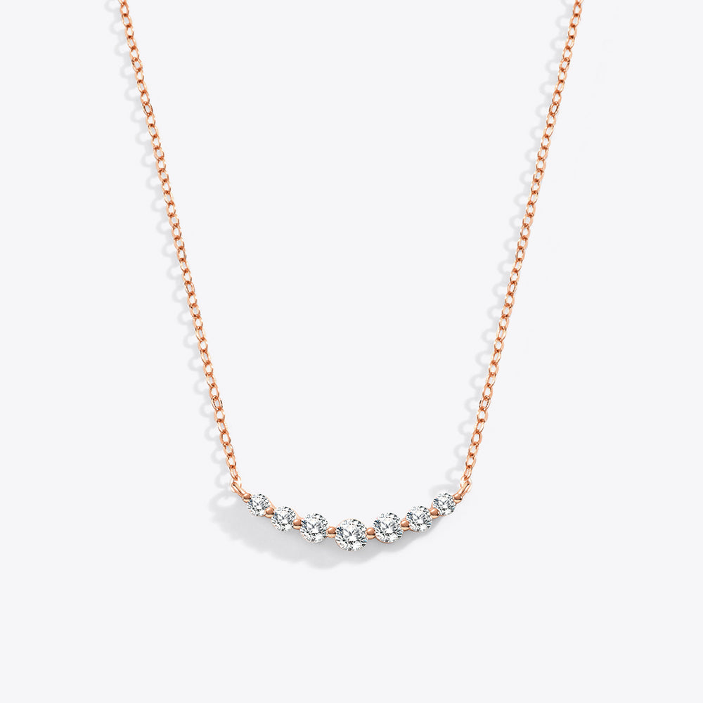Rose gold necklace with small diamonds on a white background