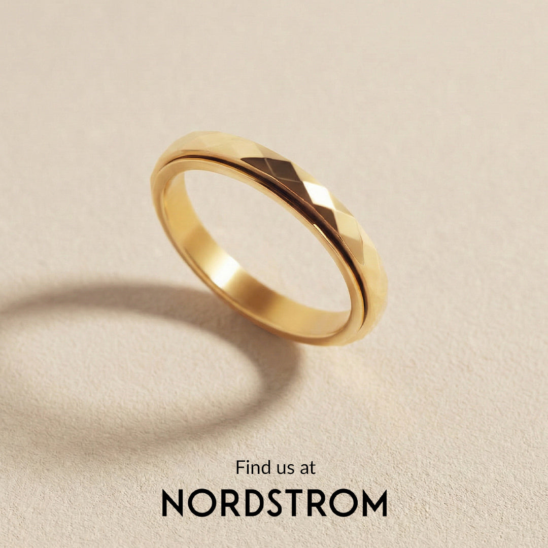 Gold ring on a beige background with 'Nordstrom' branding.