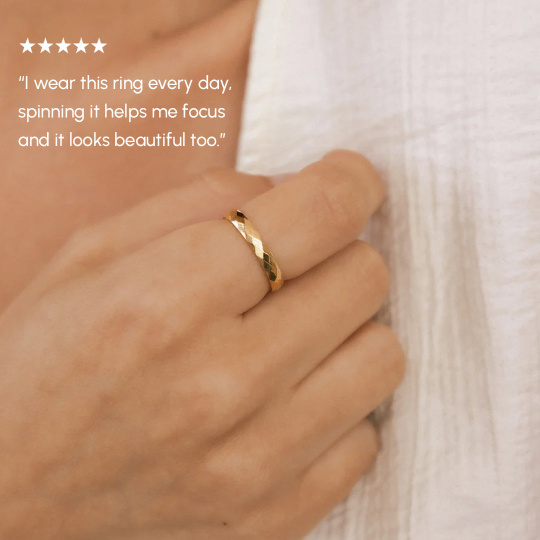 Gold ring on a finger with a quote about its benefits