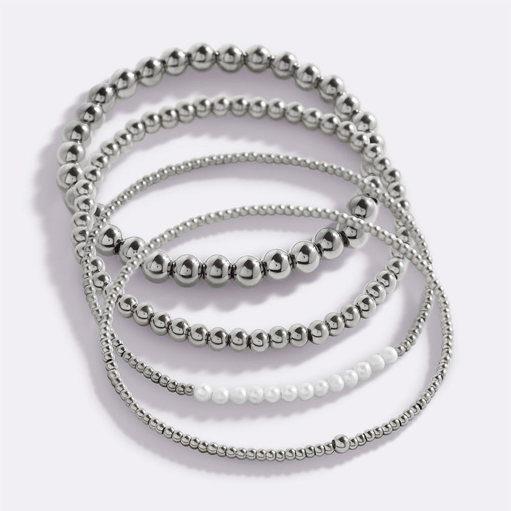 Set of silver beaded necklaces on a white background