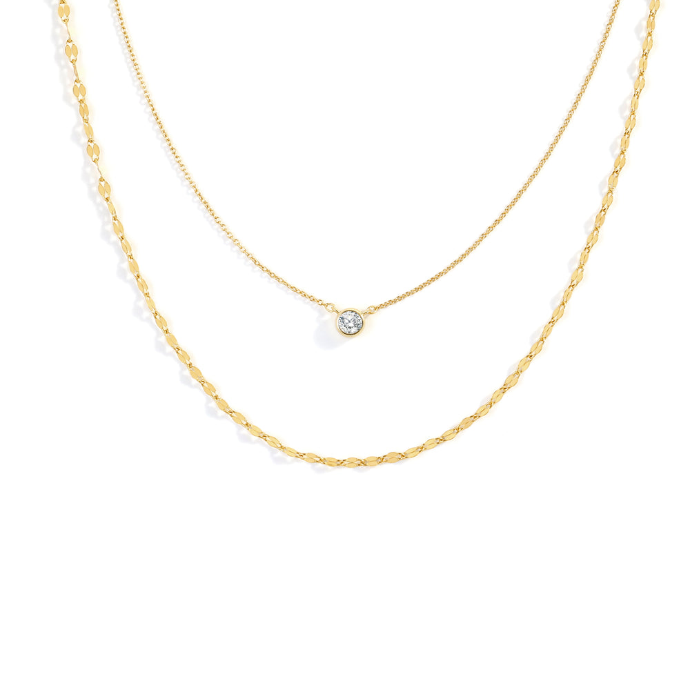 Two gold necklaces on a white background